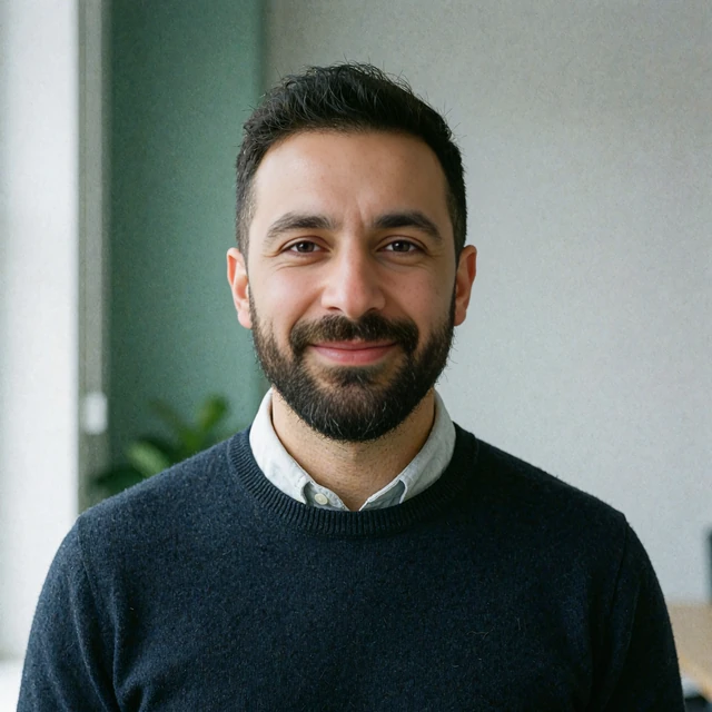 Bearded man in his mid-thirties wearing a navy sweater, illustrating a discretion-first dating site user in the elvori review